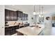 Stylish kitchen with dark cabinetry, granite countertops, and an island, perfect for meal preparation at 7379 47Th Avenue E Cir, Bradenton, FL 34203