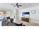 Relaxing living room features access to the pool area, a ceiling fan, and a large television at 7379 47Th Avenue E Cir, Bradenton, FL 34203