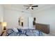 Spacious bedroom featuring a tray ceiling, ceiling fan, and plenty of closet space with an attached bathroom at 7379 47Th Avenue E Cir, Bradenton, FL 34203