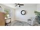 Bright home office features a ceiling fan, an accent chair, a small desk, and a window at 7379 47Th Avenue E Cir, Bradenton, FL 34203