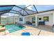 A private pool in a screened-in enclosure with a covered patio and ample seating at 7379 47Th Avenue E Cir, Bradenton, FL 34203