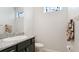 This powder room features a granite vanity, framed mirror, and decorative wall towels at 7379 47Th Avenue E Cir, Bradenton, FL 34203