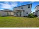 Spacious backyard featuring a covered patio, lush lawn, and meticulously landscaped garden beds at 7533 Nighthawk Drive, Sarasota, FL 34241