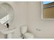 Clean half-bathroom with a pedestal sink, modern fixtures, and a neutral color palette at 7533 Nighthawk Drive, Sarasota, FL 34241
