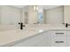 Bathroom vanity features white stone counters with black hardware at 7533 Nighthawk Drive, Sarasota, FL 34241