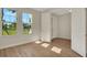 Bright, airy bedroom featuring wood floors, a large window, and two entryways at 7533 Nighthawk Drive, Sarasota, FL 34241