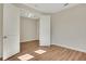 This bright bedroom features laminate wood floors and an open doorway into an adjoining room at 7533 Nighthawk Drive, Sarasota, FL 34241