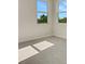 Bedroom with carpet flooring and view of green trees from the windows at 7533 Nighthawk Drive, Sarasota, FL 34241