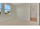 Bright bedroom with neutral carpet, white walls, large window with natural light, and white trim at 7533 Nighthawk Drive, Sarasota, FL 34241