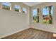 Neutral bedroom with wood-look flooring, a row of windows, and ample natural light at 7533 Nighthawk Drive, Sarasota, FL 34241