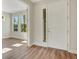 Bright entryway with wood floors, white trim, and a front door with a window at 7533 Nighthawk Drive, Sarasota, FL 34241