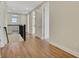 Hallway boasts beautiful wood floors, sleek metal railing, and several white doors at 7533 Nighthawk Drive, Sarasota, FL 34241