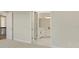 Hallway leading to bathroom with modern white cabinets and countertops at 7533 Nighthawk Drive, Sarasota, FL 34241