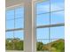 Windows offer natural light with exterior views of mature trees and blue skies at 7533 Nighthawk Drive, Sarasota, FL 34241