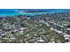 Breathtaking aerial view of a waterfront community with lush greenery and turquoise waters at 755 Edgemere Ln, Sarasota, FL 34242