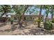 Spacious backyard with mature trees and a wood deck off of the back of the home at 755 Edgemere Ln, Sarasota, FL 34242
