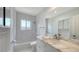 Bright bathroom features marble countertops, tub, and white tiling around shower and backsplash at 755 Edgemere Ln, Sarasota, FL 34242