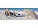 Relax on Siesta Beach with beach chairs, umbrella, and toys at 755 Edgemere Ln, Sarasota, FL 34242