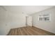 This bedroom features a modern aesthetic with a window and wood floors at 755 Edgemere Ln, Sarasota, FL 34242