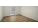 Bright bedroom with a large window and wood-look floors at 755 Edgemere Ln, Sarasota, FL 34242