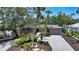 Charming home with a brick driveway and lush landscaping creates inviting curb appeal at 755 Edgemere Ln, Sarasota, FL 34242