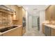 Modern kitchen with stainless steel appliances, tiled floors, and sleek countertops at 755 Edgemere Ln, Sarasota, FL 34242