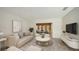Bright living room features a neutral color palette, stylish furniture, and access to another living space at 755 Edgemere Ln, Sarasota, FL 34242