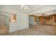 Open living and dining spaces feature tile flooring, a pass through kitchen, and views of the yard at 755 Edgemere Ln, Sarasota, FL 34242