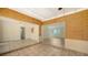 Spacious living room features a unique wall covering, white ceilings and trim, and tile flooring at 755 Edgemere Ln, Sarasota, FL 34242