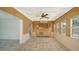 Open sun room features tile flooring, unique wall covering, and large windows for ample natural light at 755 Edgemere Ln, Sarasota, FL 34242