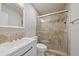 Bathroom with tiled shower with glass doors and white vanity with solid surface countertop at 7595 Berwick St, North Port, FL 34287