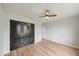 This bedroom features wood-look flooring and a ceiling fan along with a closet at 7595 Berwick St, North Port, FL 34287