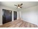 Bedroom featuring wood look floors, ceiling fan and closet with natural light at 7595 Berwick St, North Port, FL 34287