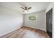 Bedroom featuring wood look floors, ceiling fan and closet with natural light at 7595 Berwick St, North Port, FL 34287