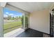 Relaxing screened front porch with wood flooring perfect for enjoying the outdoors at 7595 Berwick St, North Port, FL 34287