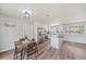 Bright kitchen features stainless steel appliances, an island with a dark countertop, and a dining area at 7595 Berwick St, North Port, FL 34287
