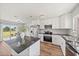 Modern kitchen with stainless steel appliances, granite countertops, and a seamless transition to the backyard patio at 7595 Berwick St, North Port, FL 34287