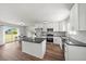 Modern kitchen with stainless steel appliances, center island, and wood flooring at 7595 Berwick St, North Port, FL 34287