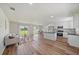 Spacious open-concept living area with modern furniture and wood flooring at 7595 Berwick St, North Port, FL 34287