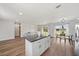 Bright open-concept living area with modern furniture and wood flooring at 7595 Berwick St, North Port, FL 34287