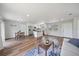Open-concept living room with modern decor, seamlessly connected to the kitchen and dining area, and wood-look floors at 7595 Berwick St, North Port, FL 34287