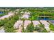 Aerial view capturing a residential neighborhood with neatly arranged homes, lush trees, and waterways at 7716 Uliva Way, Sarasota, FL 34238