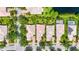 Birds-eye view of homes with well-kept lawns and landscaping, plus a pool and lake in the background at 7716 Uliva Way, Sarasota, FL 34238