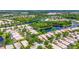 Expansive aerial view showcases a residential community with winding waterways and manicured green spaces at 7716 Uliva Way, Sarasota, FL 34238