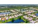 Expansive aerial view of a waterfront community, featuring homes along lakes and lush, mature landscaping at 7716 Uliva Way, Sarasota, FL 34238
