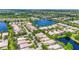 Scenic aerial view showcases a community with diverse waterways, serene lakes, and lush landscaping at 7716 Uliva Way, Sarasota, FL 34238