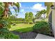 Beautifully landscaped backyard featuring lush greenery and tropical plants in a well maintained yard space at 7716 Uliva Way, Sarasota, FL 34238