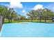 Bright blue community basketball court with durable surface and sturdy hoops at 7716 Uliva Way, Sarasota, FL 34238