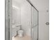 Bathroom featuring vanity, toilet, and shower with glass doors at 7716 Uliva Way, Sarasota, FL 34238