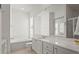 Bright bathroom with tub, toilet, large mirror, and double vanity with white cabinets at 7716 Uliva Way, Sarasota, FL 34238